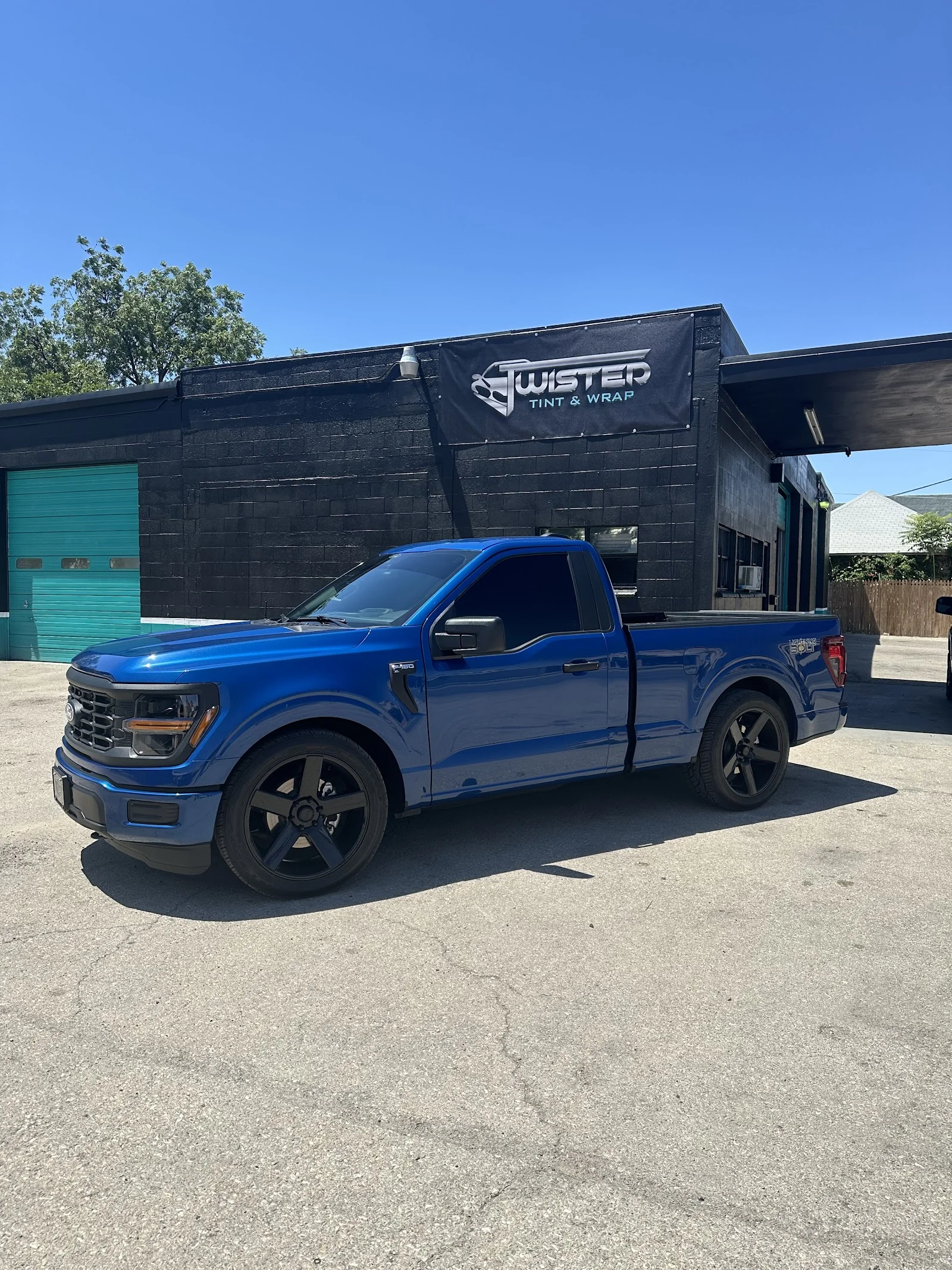 Inside Twisted Tint & Wrap — wrap shop and install bay